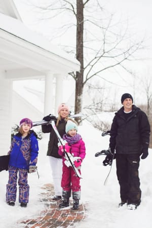 Ski family walks outside in snow, Cottages at Bay Harbor