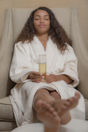 Woman relaxing with champagne at The Spa at Inn at Bay Harbor