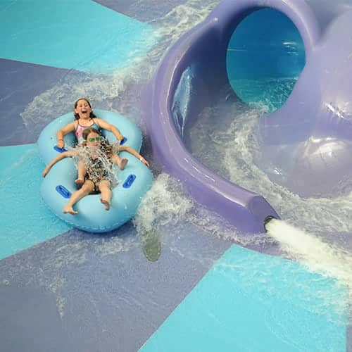Young girls on waterslide at Avalanche Bay Indoor Waterpark