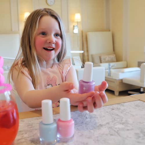 Young girl picks color in The Spa's nail room