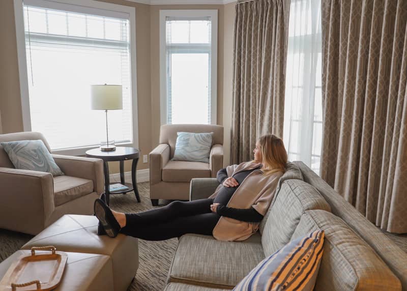 Pregnant woman in King Suite, Bay Harbor Babymoon package in serene northern Michigan