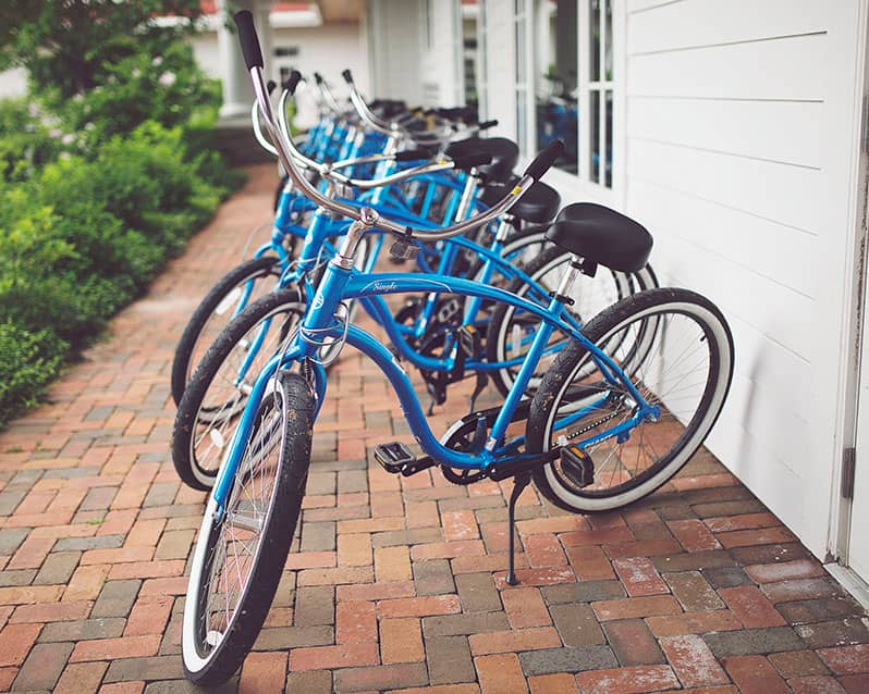 Blue beach cruiser bicycles, lined up by the Inn