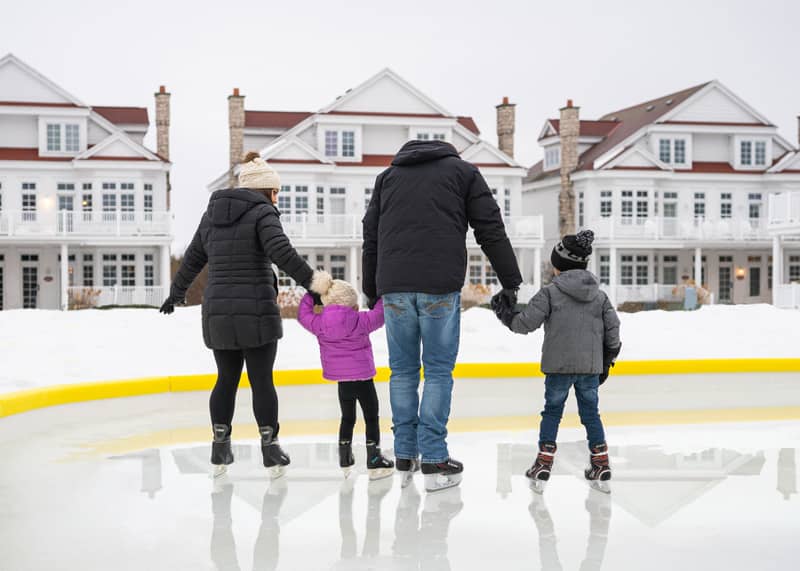 Family skating, outdoor ice rink, Lakeside Cottages at Bay Harbor