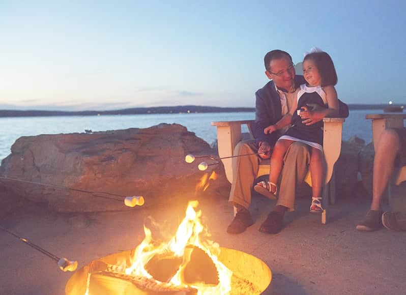Young girl and father roast marshmallows, Inn at Bay Harbor