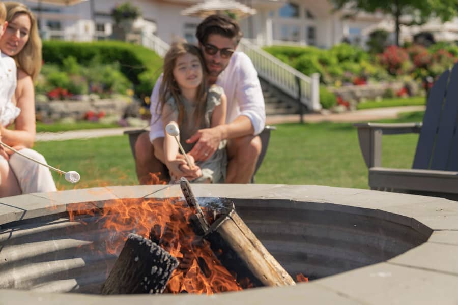 Father and daughter roast marshmallows, Inn at Bay Harbor