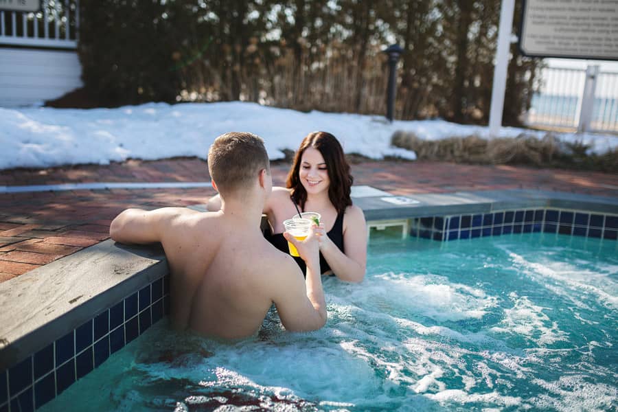 Couple toasts in hot tub, winter