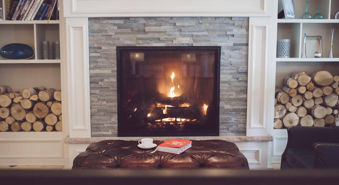 Cup of tea and book in front of lobby fireplace
