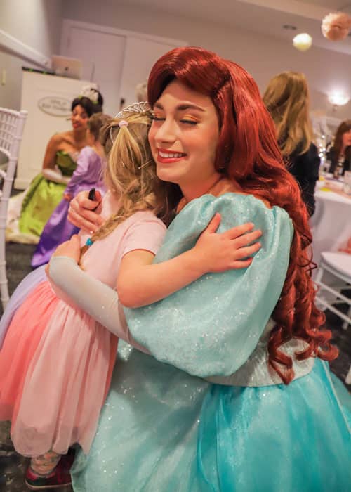 Ariel and a young guest enjoys a special hug during meet-and-greets