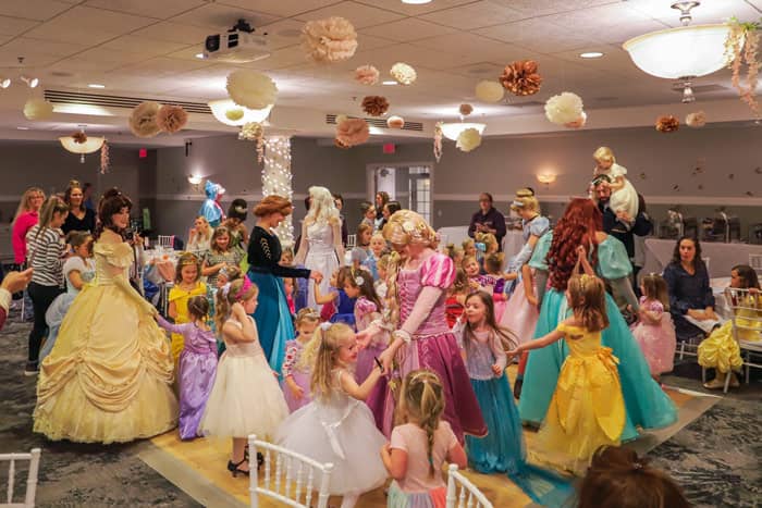 Princesses and guests enjoy dancing together at the end of the event