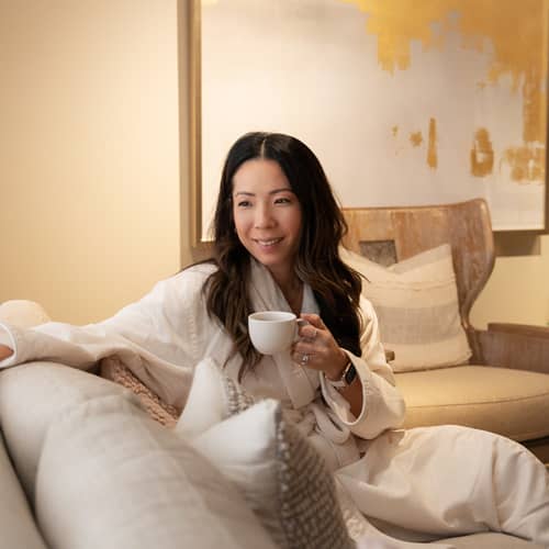 Woman relaxes with tea at The Spa, Inn at Bay Harbor