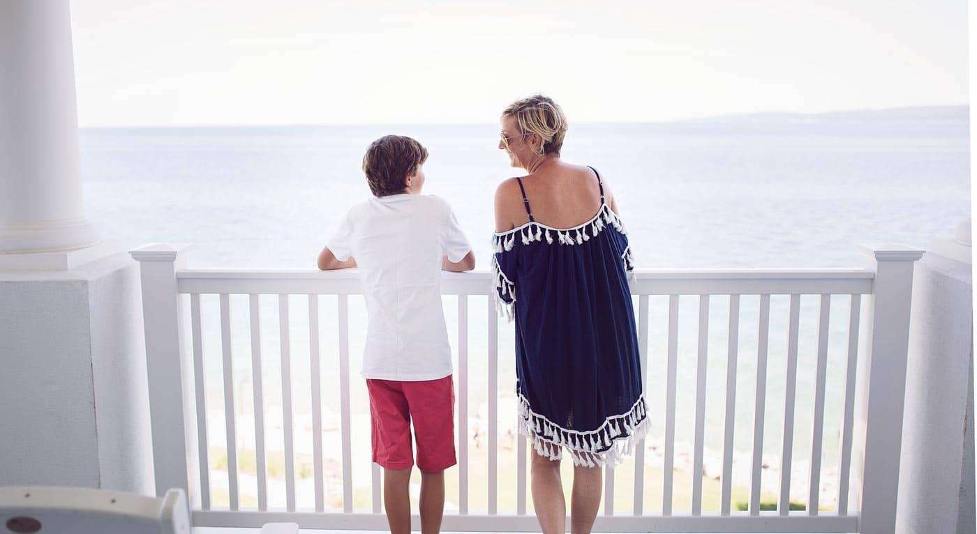 Mother and son look at Lake Michigan from Inn balcony