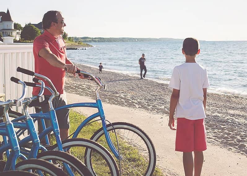 Father and son with blue beach cruiser bicycles, Inn at Bay Harbor