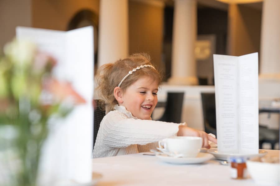 Young girl smiles at Afternoon Tea at Inn at Bay Harbor