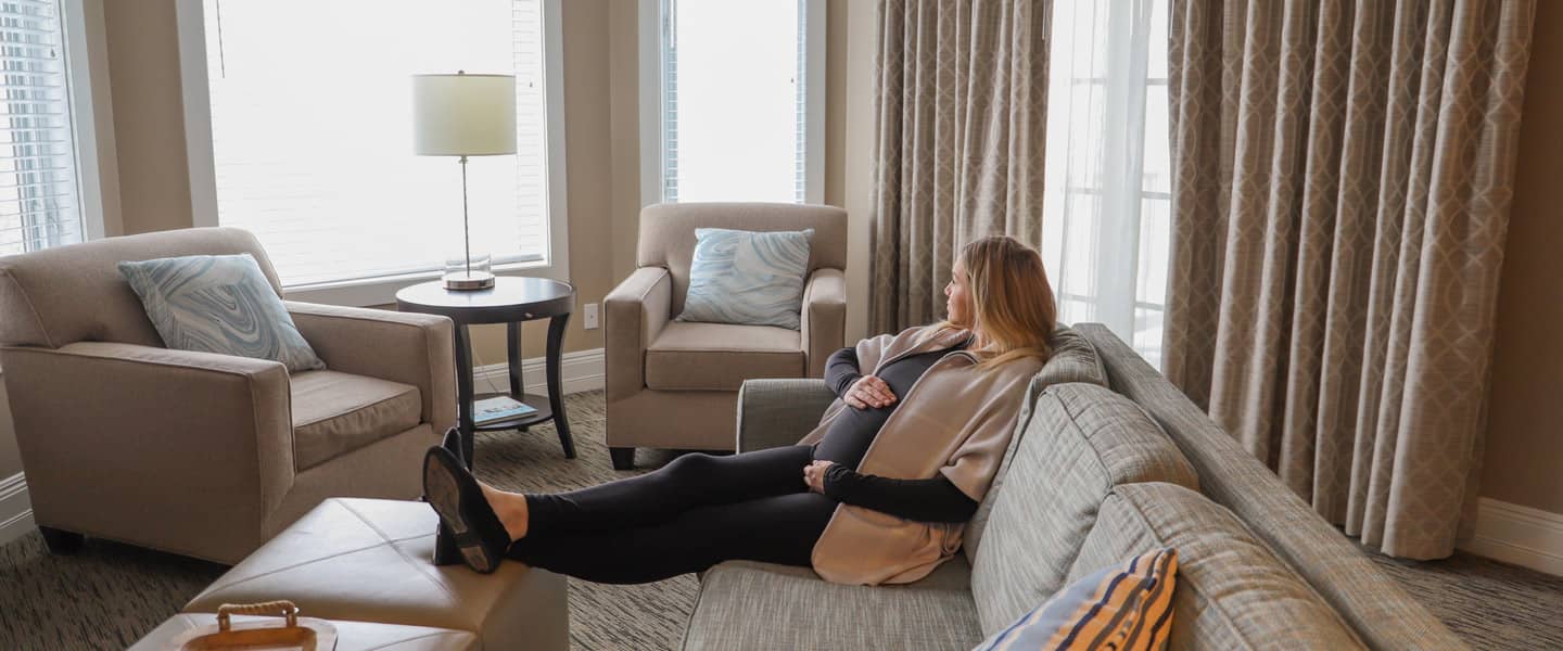 Pregnant woman in King Suite, Bay Harbor Babymoon package in serene northern Michigan